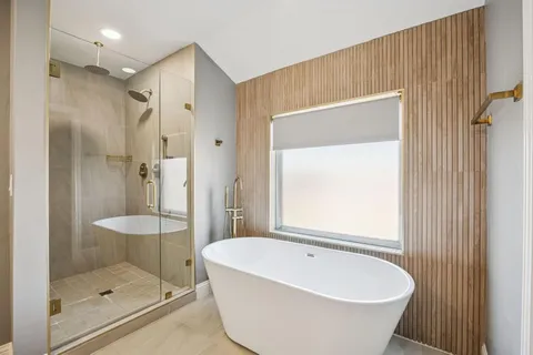 a bathroom with a bathtub and a shower