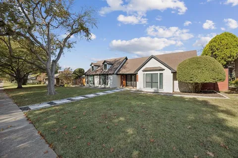 a view of a large trees in front of a house