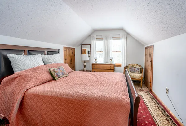 a bedroom with a bed and a large window