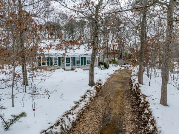 a view of a white house with a yard covered in snow