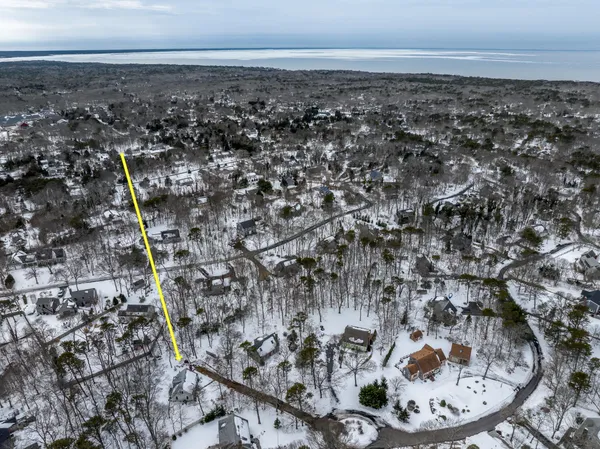 a aerial view of a house with a yard covered in snow