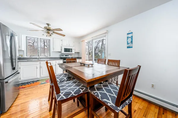 a view of a dining room with furniture window and wooden floor