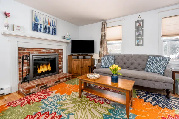 a living room with furniture a flat screen tv and a fireplace