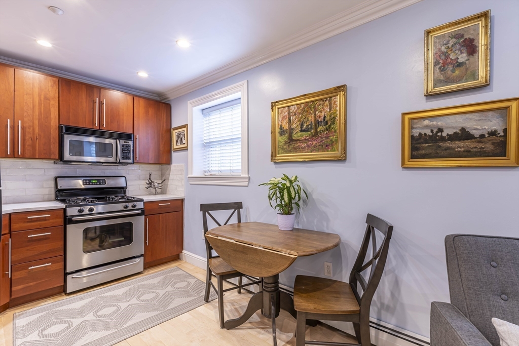 52 Cooper Street, Unit 2 Boston, MA 02113 - Photo 3 of 15 a view of a dining room with furniture window and wooden floor