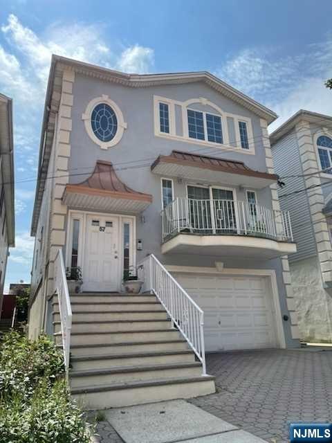 a view of a house with a small yard and wooden floor