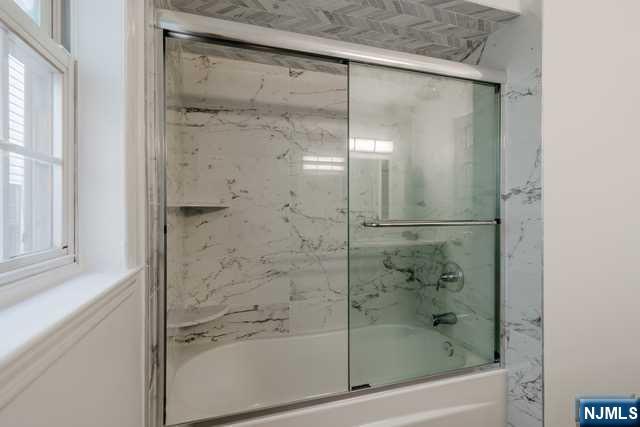 57 71st Street Guttenberg, NJ 07093 - Photo 12 of 18 a bathroom with a glass shower door