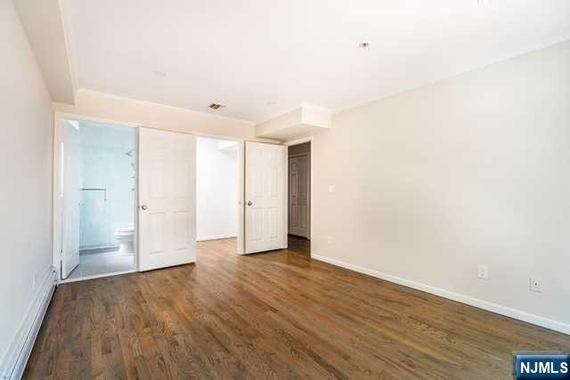 57 71st Street Guttenberg, NJ 07093 - Photo 15 of 18 a view of an empty room with wooden floor