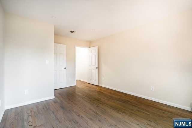 57 71st Street Guttenberg, NJ 07093 - Photo 16 of 18 a view of an empty room with wooden floor