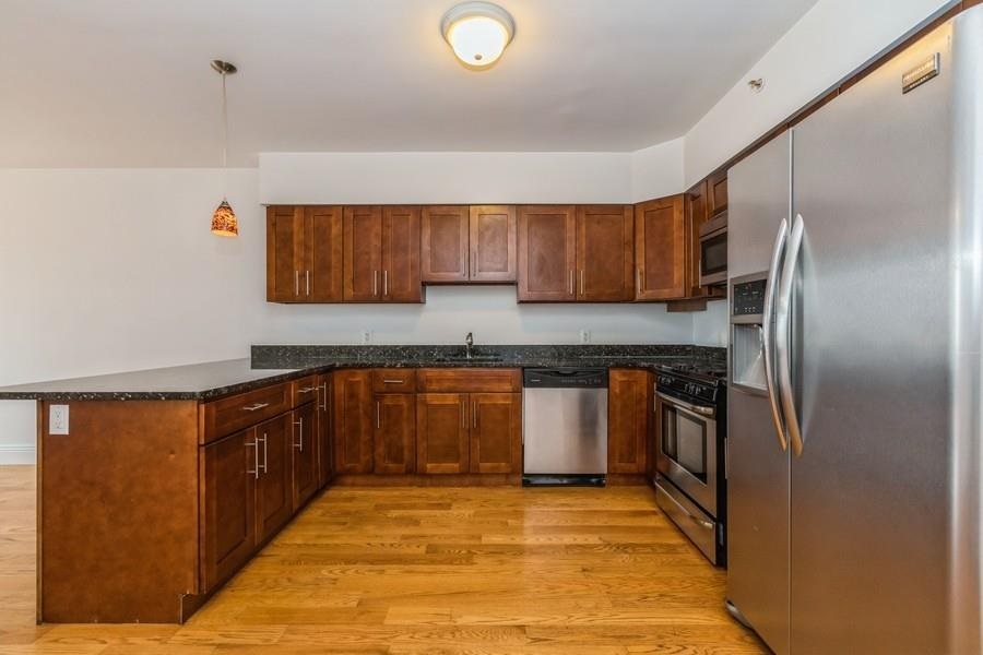 125 43rd Street, Unit 604 Union City, NJ 07087 - Photo 3 of 17 a kitchen with granite countertop a refrigerator and a sink