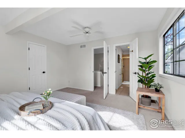 a bedroom with a bed and a potted plant