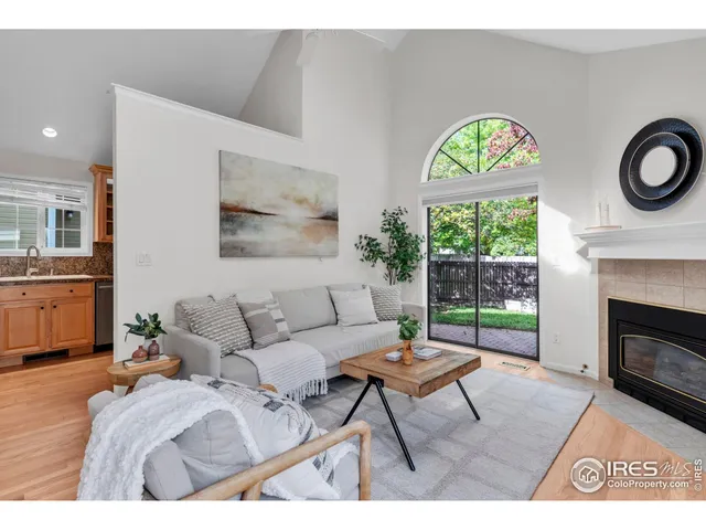 a living room with furniture a fireplace and a table