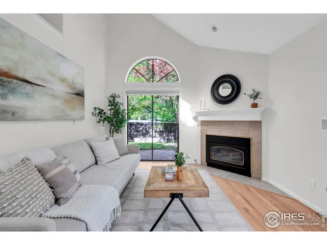 a living room with furniture a clock and a fireplace