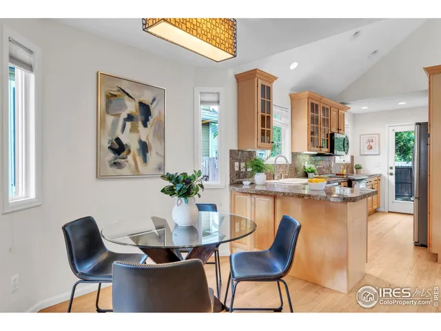 a dining room with furniture and a floor to ceiling window