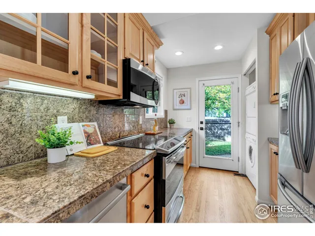 a kitchen that has a microwave a sink and a stove