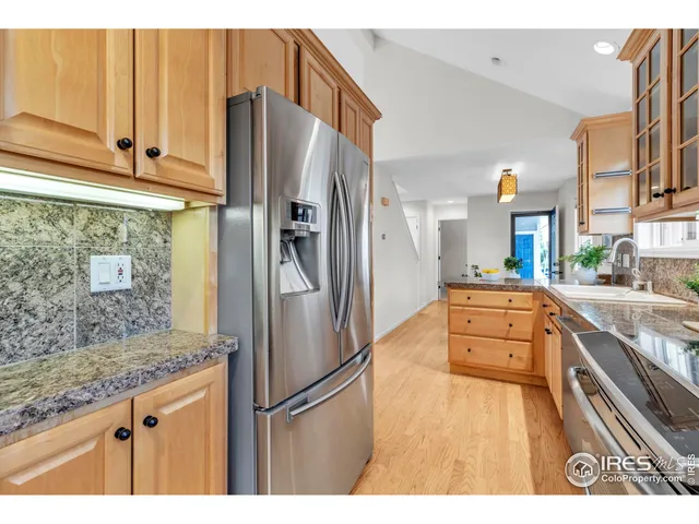 a kitchen with stainless steel appliances granite countertop a refrigerator and a sink
