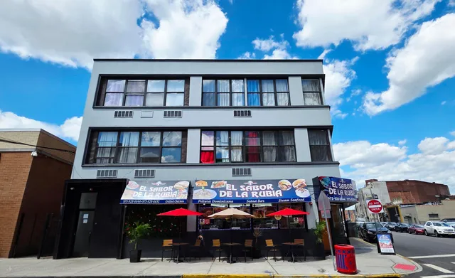 a view of building with cars parked