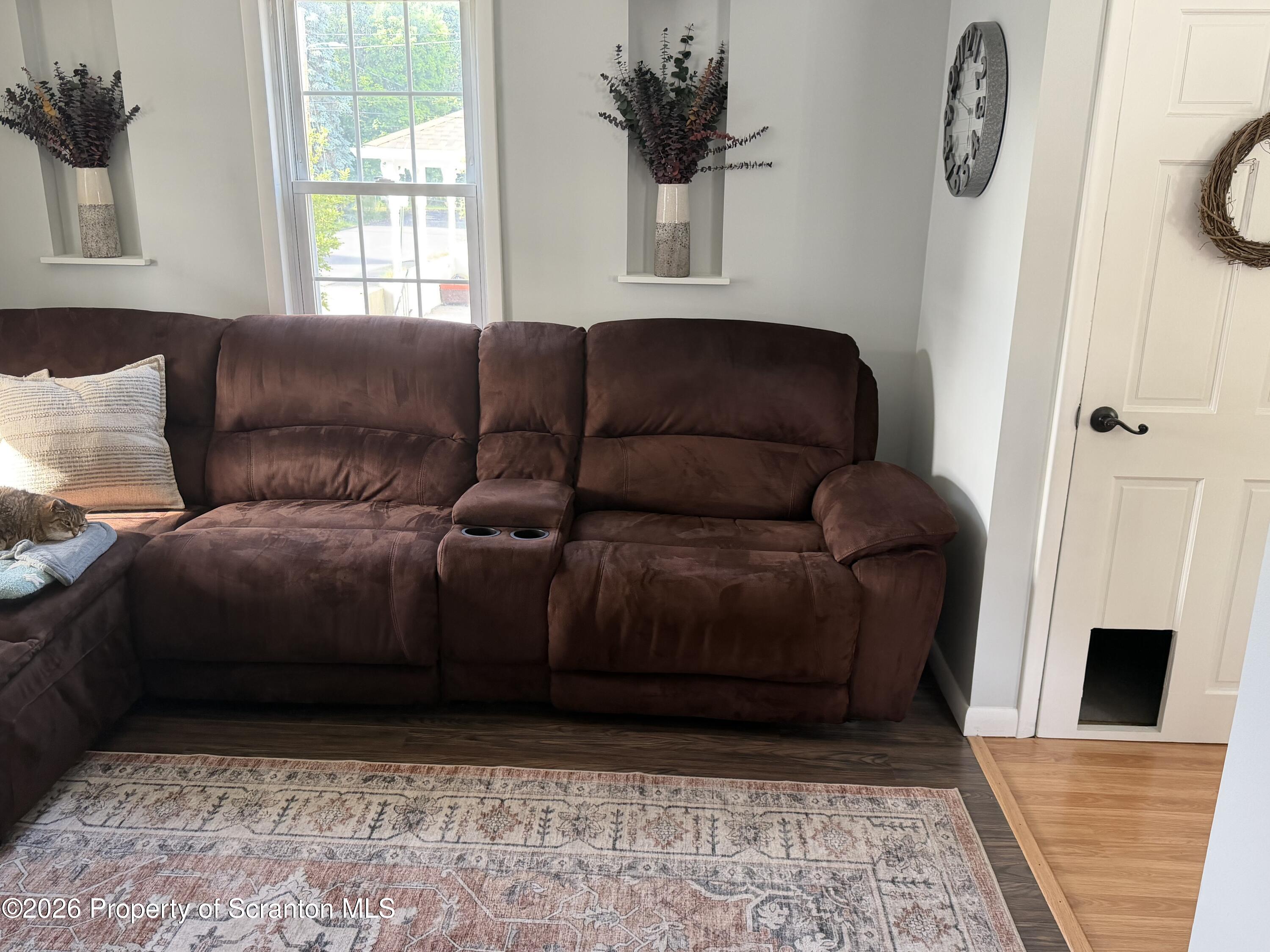 320 Haverly Street Throop, PA 18512 - Photo 12 of 27 a living room with a couch wooden floor and a fireplace