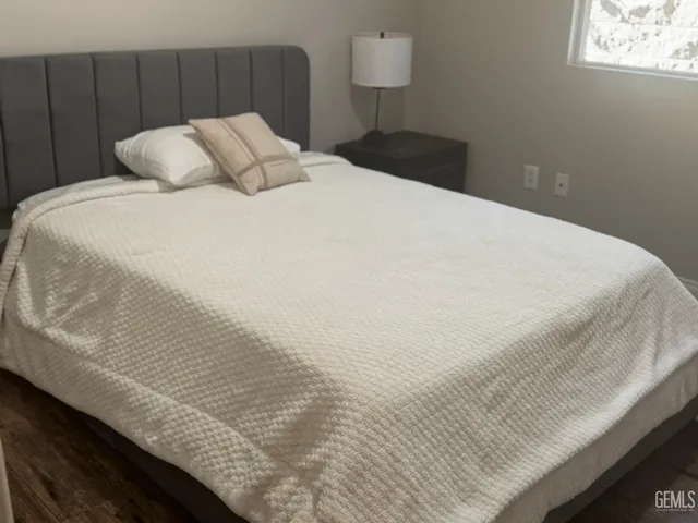 a bed sitting in a bedroom next to a wall