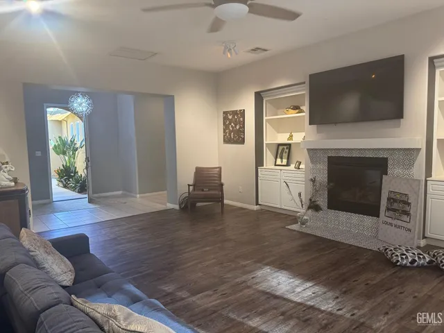 a living room with furniture a fireplace and a flat screen tv