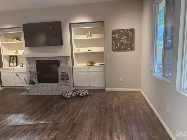 a room with a fireplace and a flat screen tv