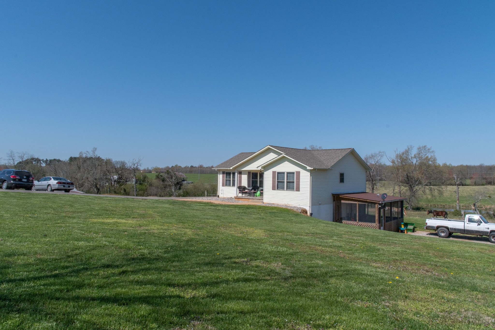 319 Wirmingham Road Monroe, TN 38573 - Photo 24 of 34 a view of a big house with a big yard and large trees