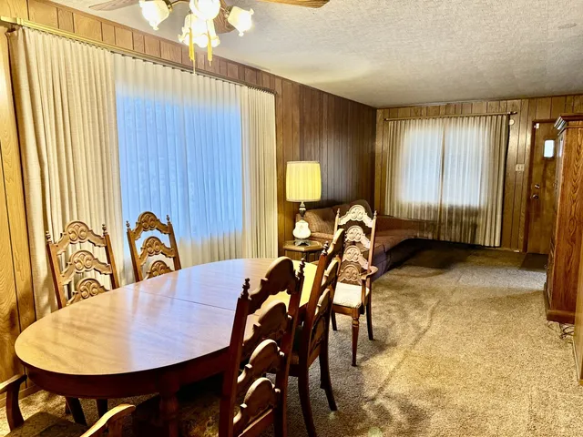 a view of a dining room with furniture and a window