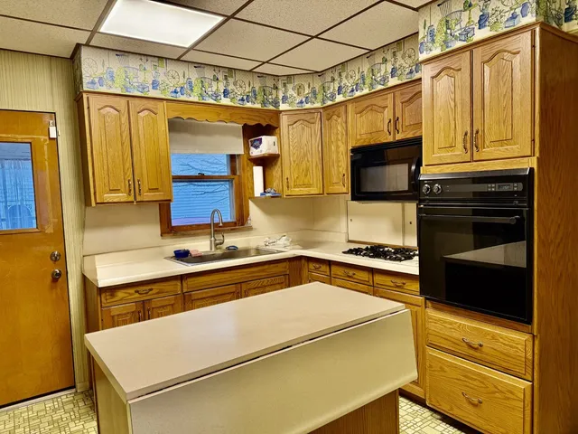 a kitchen with stainless steel appliances granite countertop a refrigerator and a stove top oven