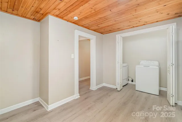 an empty room with wooden floor and closet