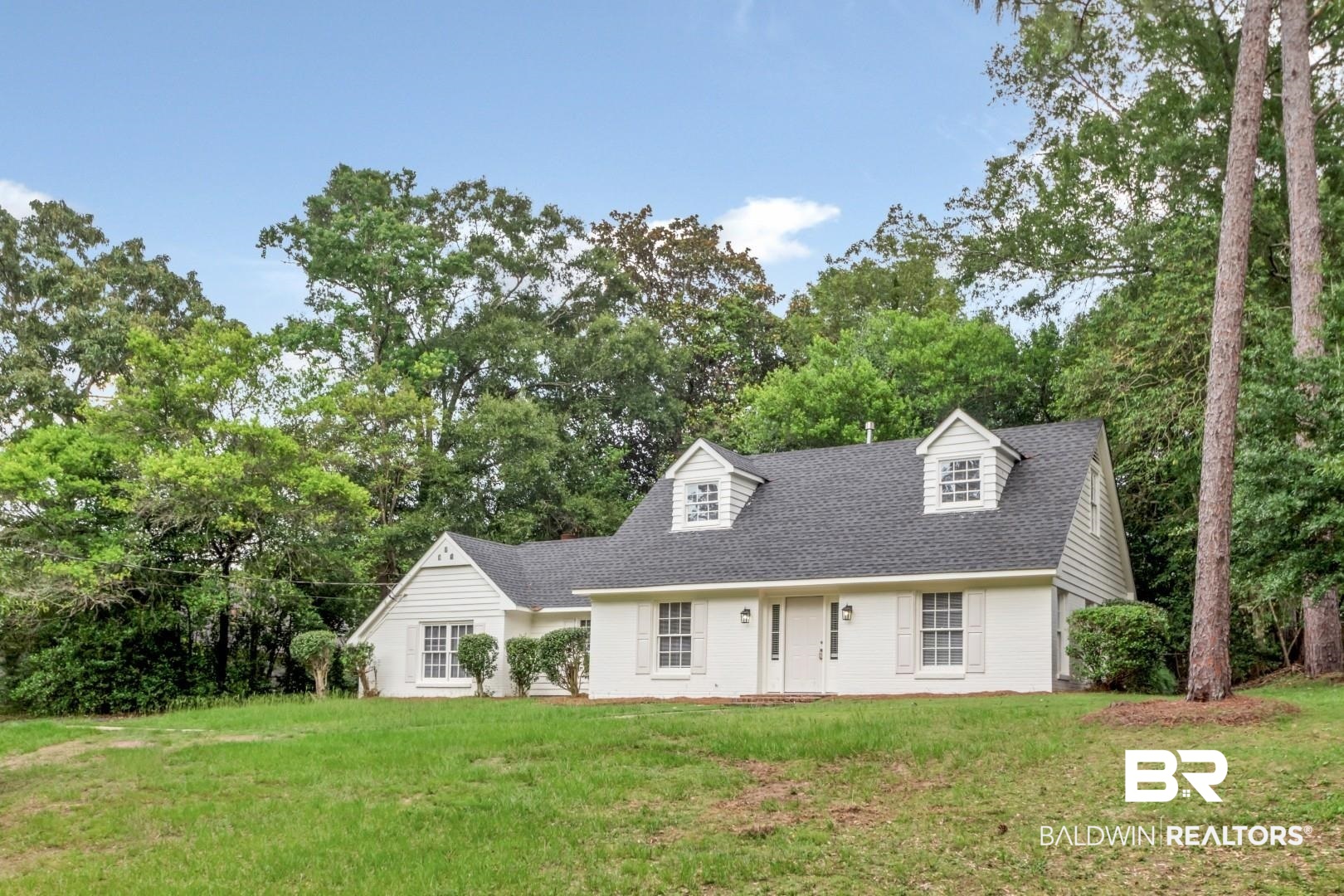 810 Nassau Drive Mobile, AL 36608 - Photo 23 of 31 Cape cod-style house with a front yard, a shingled roof, and view of scattered trees