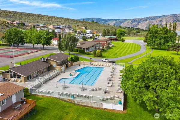 a view of a swimming pool with lawn chairs