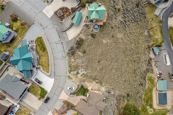 an aerial view of a swimming pool with outdoor seating