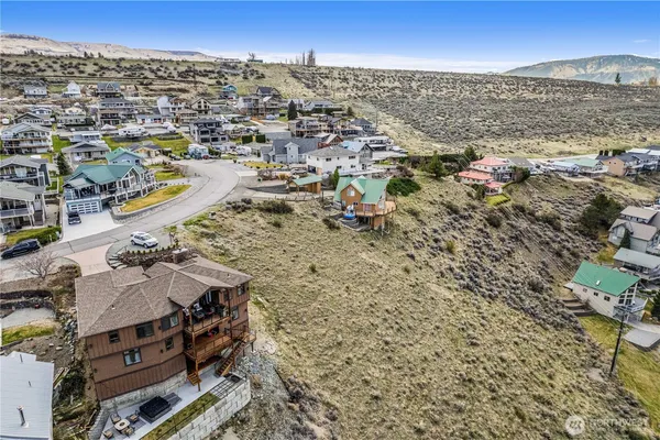 an aerial view of residential houses with outdoor space and swimming pool