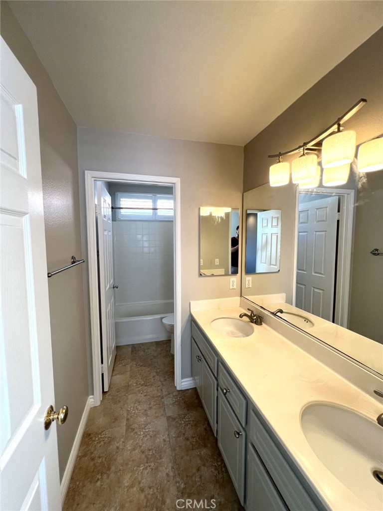14101 Visions Drive La Mirada, CA 90638 - Photo 14 of 26 a bathroom with a granite countertop sink mirror and a bathtub