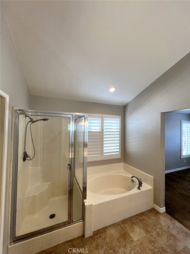 14101 Visions Drive La Mirada, CA 90638 - Photo 15 of 26 a bathroom with a bathtub and a shower