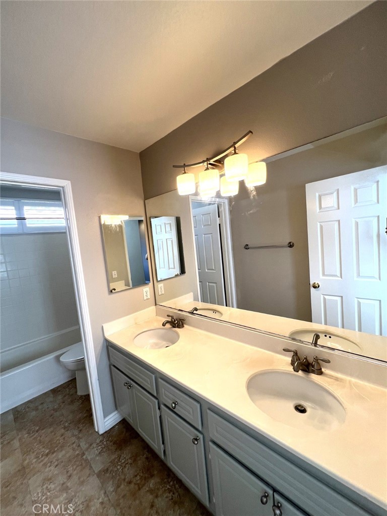 14101 Visions Drive La Mirada, CA 90638 - Photo 16 of 26 a bathroom with a double vanity sink and mirror