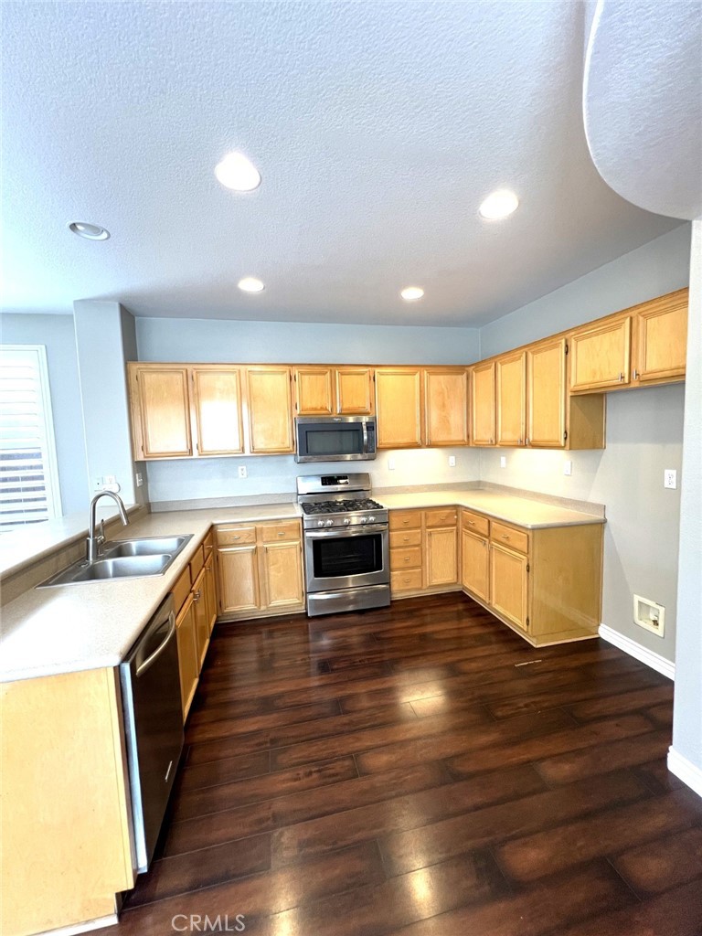 14101 Visions Drive La Mirada, CA 90638 - Photo 5 of 26 a large kitchen with granite countertop a large counter top a sink a window and stainless steel appliances