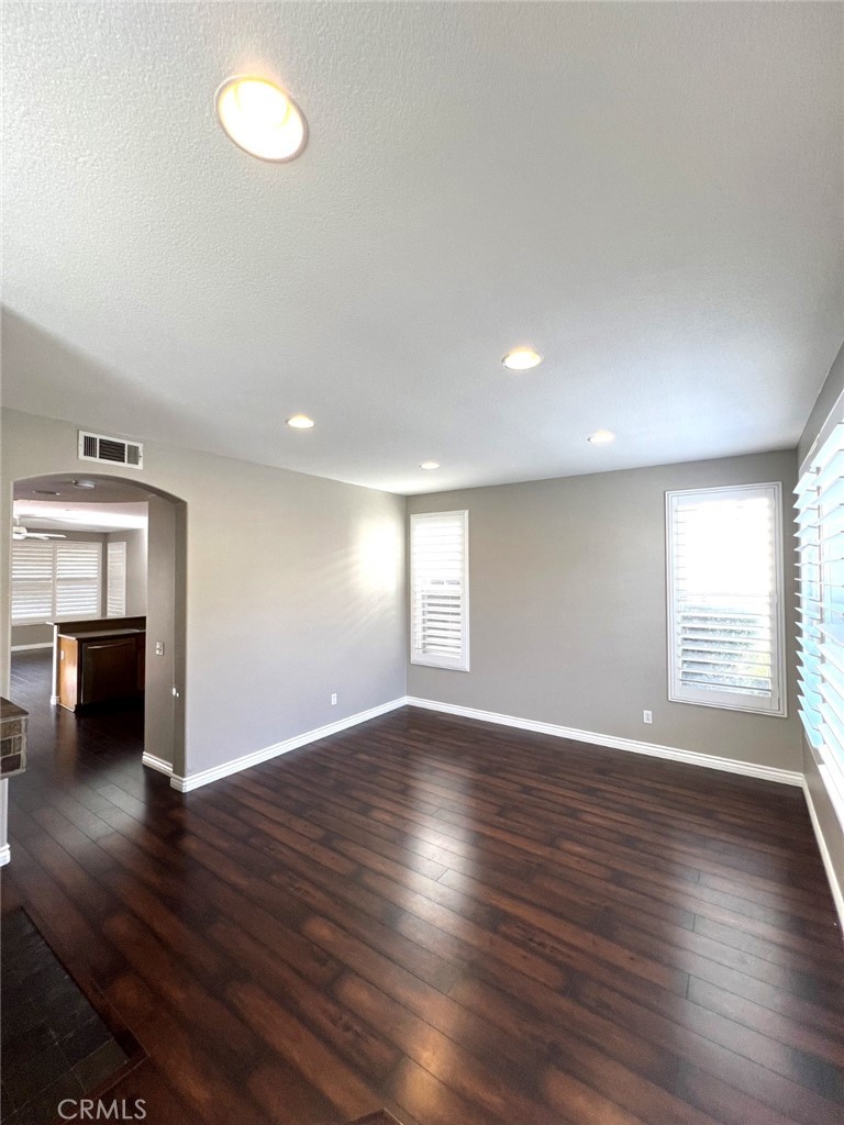 14101 Visions Drive La Mirada, CA 90638 - Photo 7 of 26 an empty room with wooden floor and windows