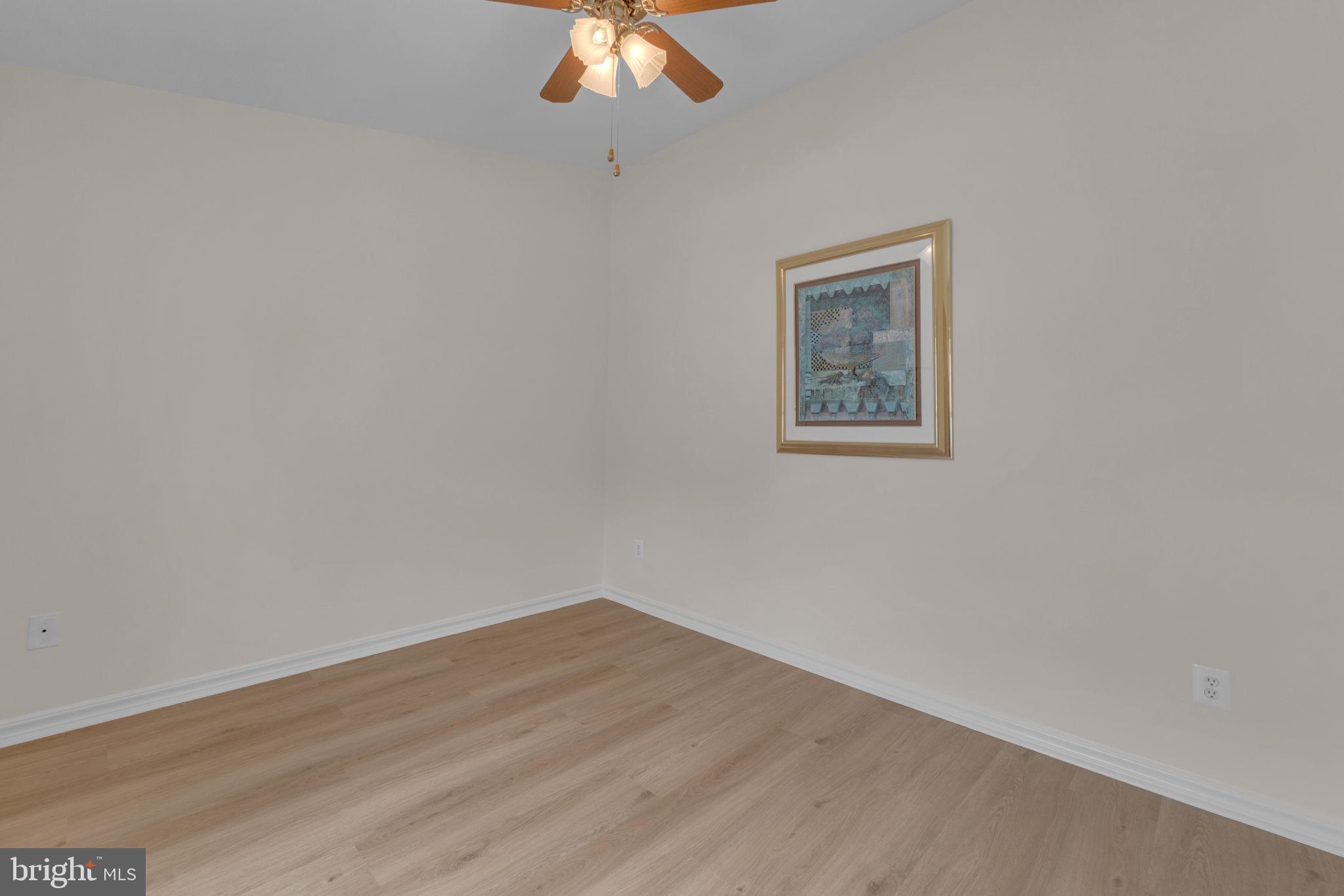 801 Freeport Way Williamstown, NJ 08094 - Photo 6 of 29 a view of a small space with wooden floor and a chandelier fan