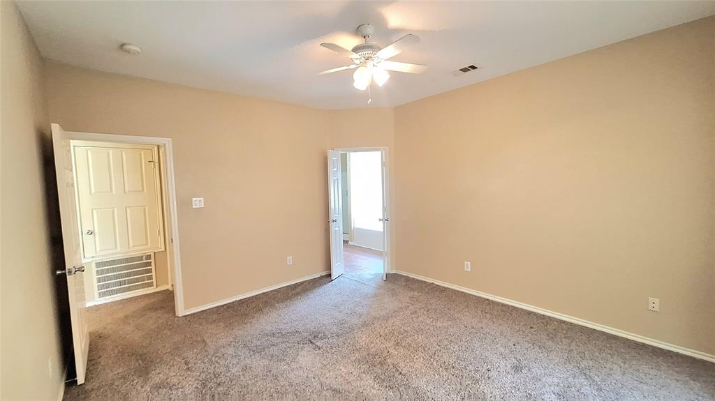 953 Hannah Way Dallas, TX 75253 - Photo 19 of 22 Carpeted interior room featuring neutral wall paint, white trim, a ceiling fan with integrated lighting, and a closet with a louvered panel
