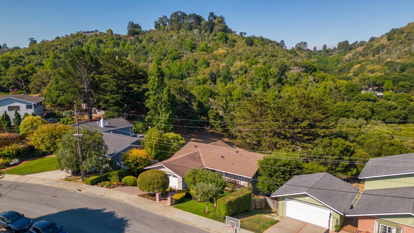 1990 Los Altos Drive San Mateo, CA 94402 - Photo 2 of 34 an aerial view of a house with yard and mountain view in back