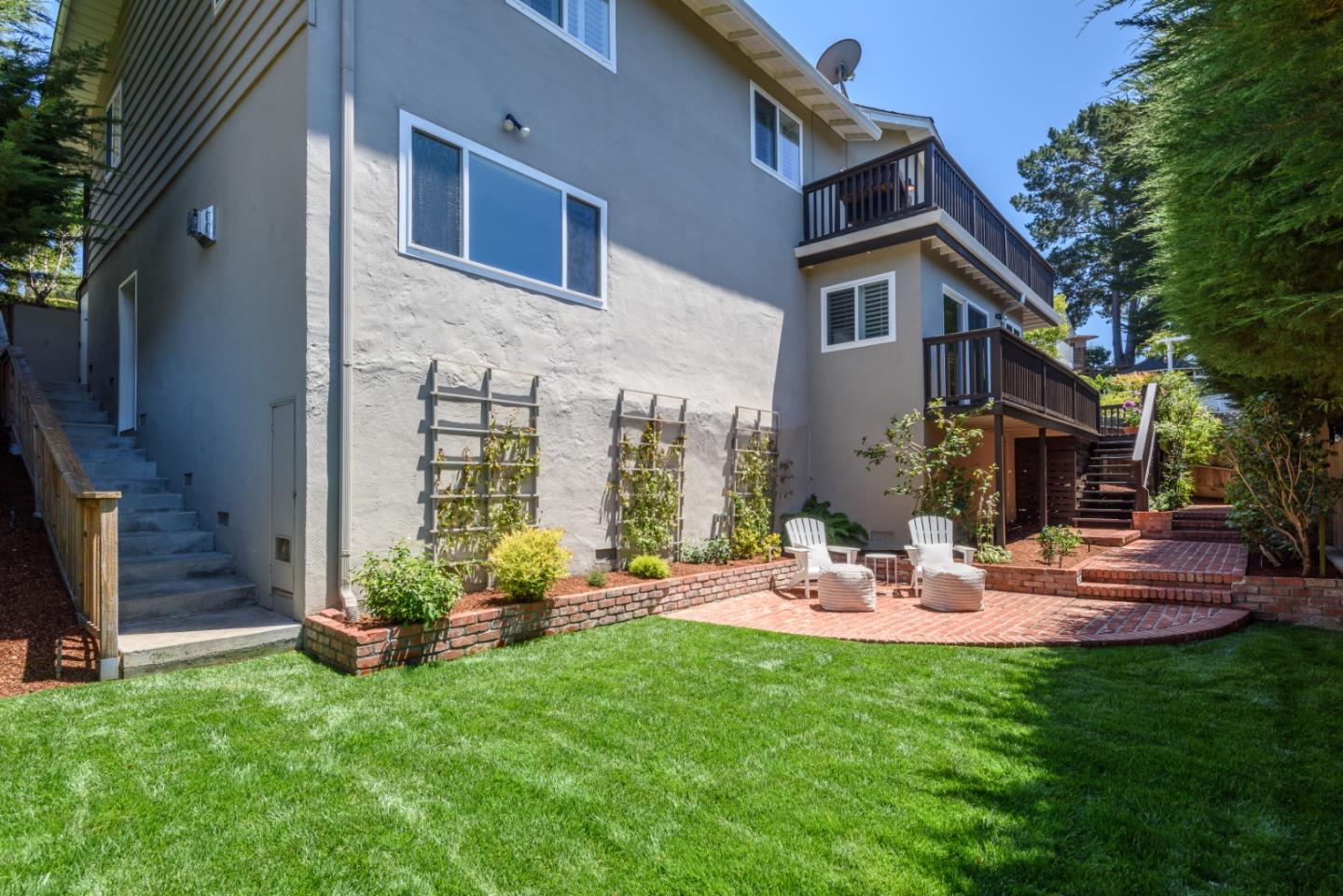 1990 Los Altos Drive San Mateo, CA 94402 - Photo 27 of 34 a view of a patio with table and chairs potted plants and a palm tree