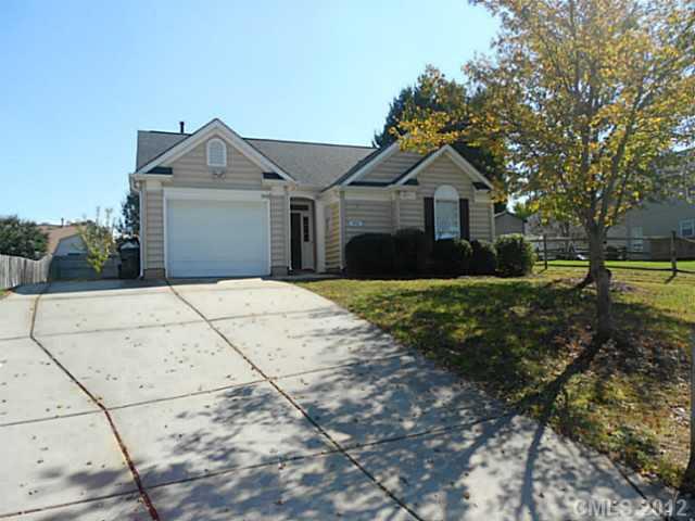 906 Treasure Place Southwest Concord, NC 28025 - Photo 1 of 15 a front view of a house with a yard and garage