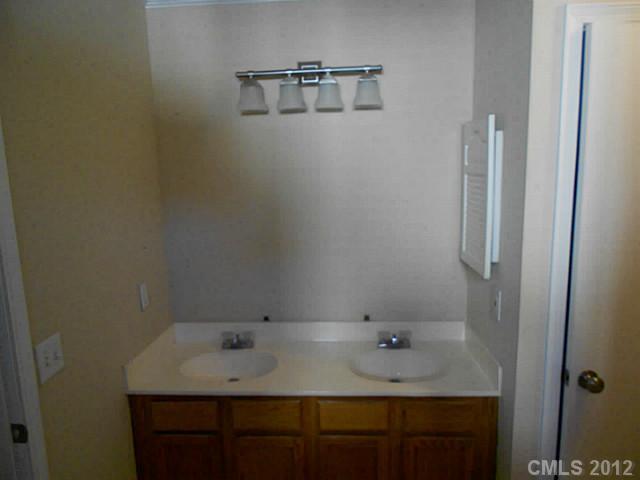 906 Treasure Place Southwest Concord, NC 28025 - Photo 9 of 15 a bathroom with a granite countertop sink and a mirror