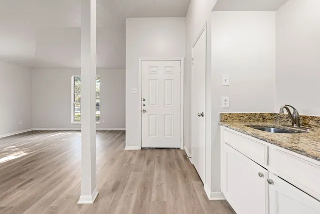 a view of a kitchen from a hallway