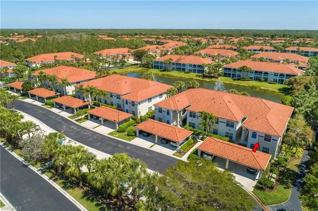 an aerial view of residential houses with outdoor space and trees all around