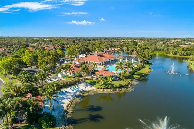 an aerial view of residential houses with outdoor space and river