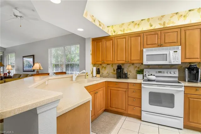 a kitchen with a sink appliances and cabinets
