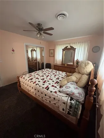 a bedroom with a bed and a mirror