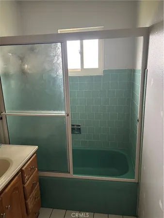 a bathroom with a shower and a sink