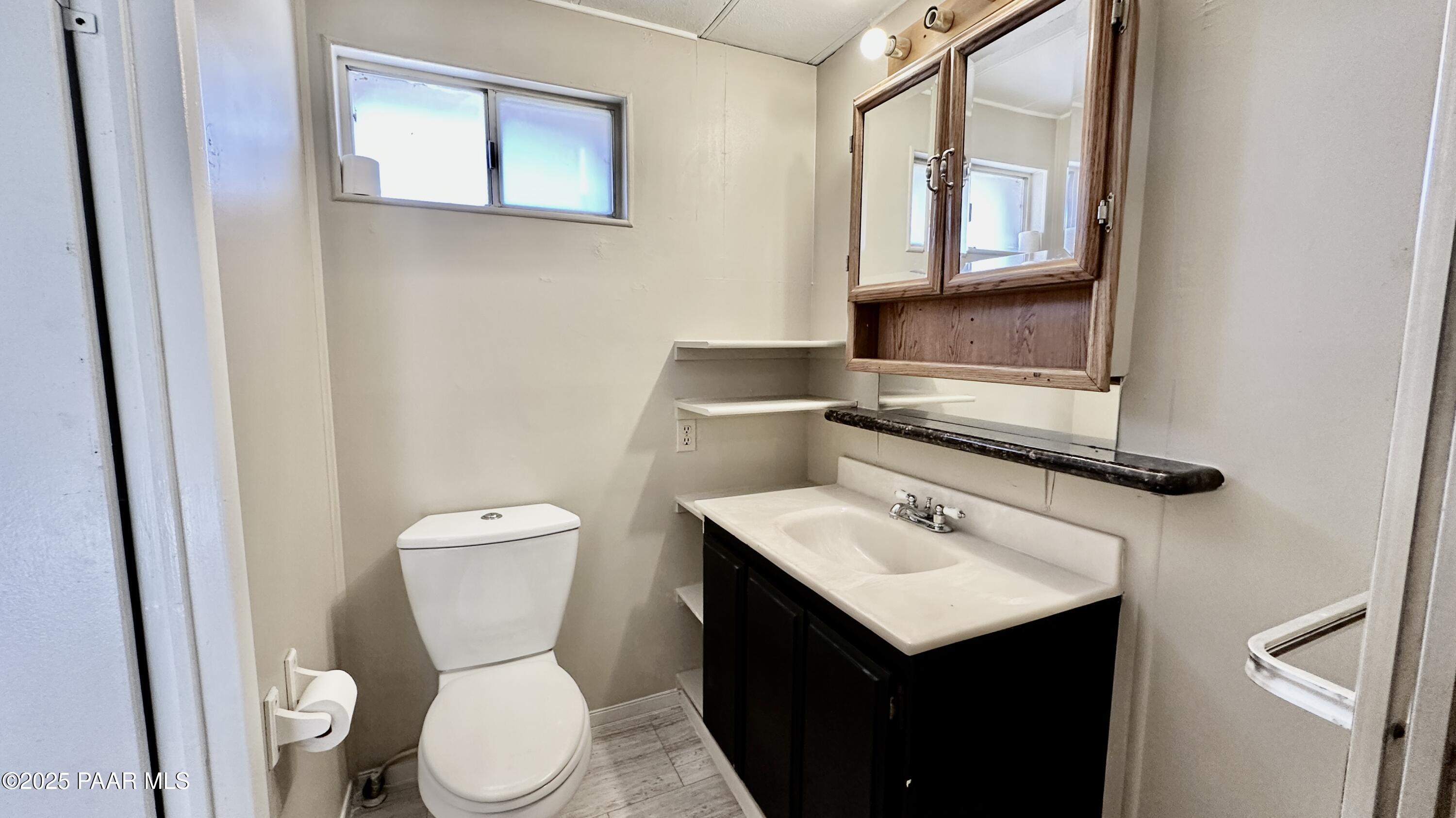 1331 East Red Cinder Road Chino Valley, AZ 86323 - Photo 15 of 58 a bathroom with a toilet sink and mirror